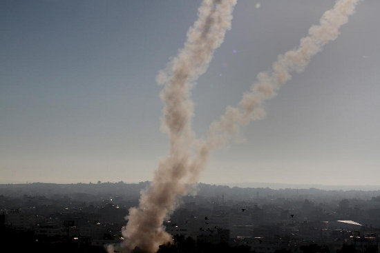 Smoke trails from rockets launched by Palestinian fighters in Gaza towards Israel are seen over Gaza City, 15 November