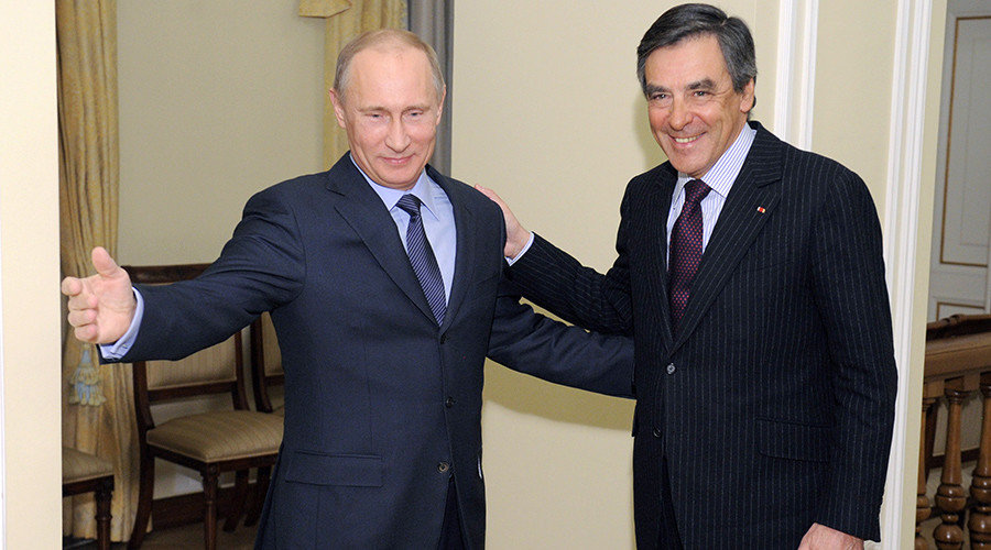 Russia's President Vladimir Putin (L) welcomes France's former Prime Minister Francois Fillon
