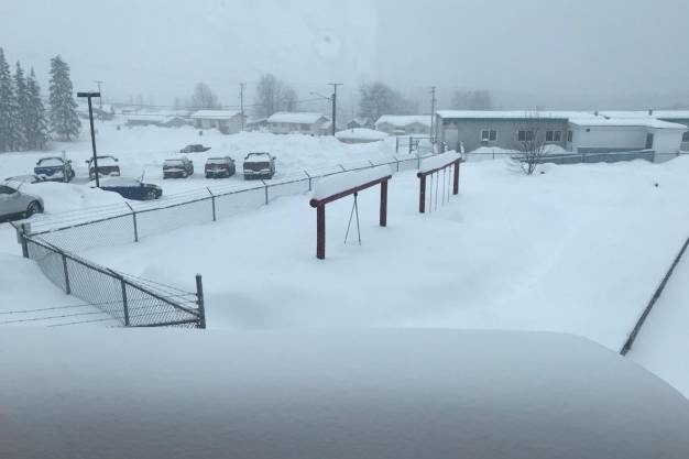 In Burns Lake, the swings are buried under the snow.