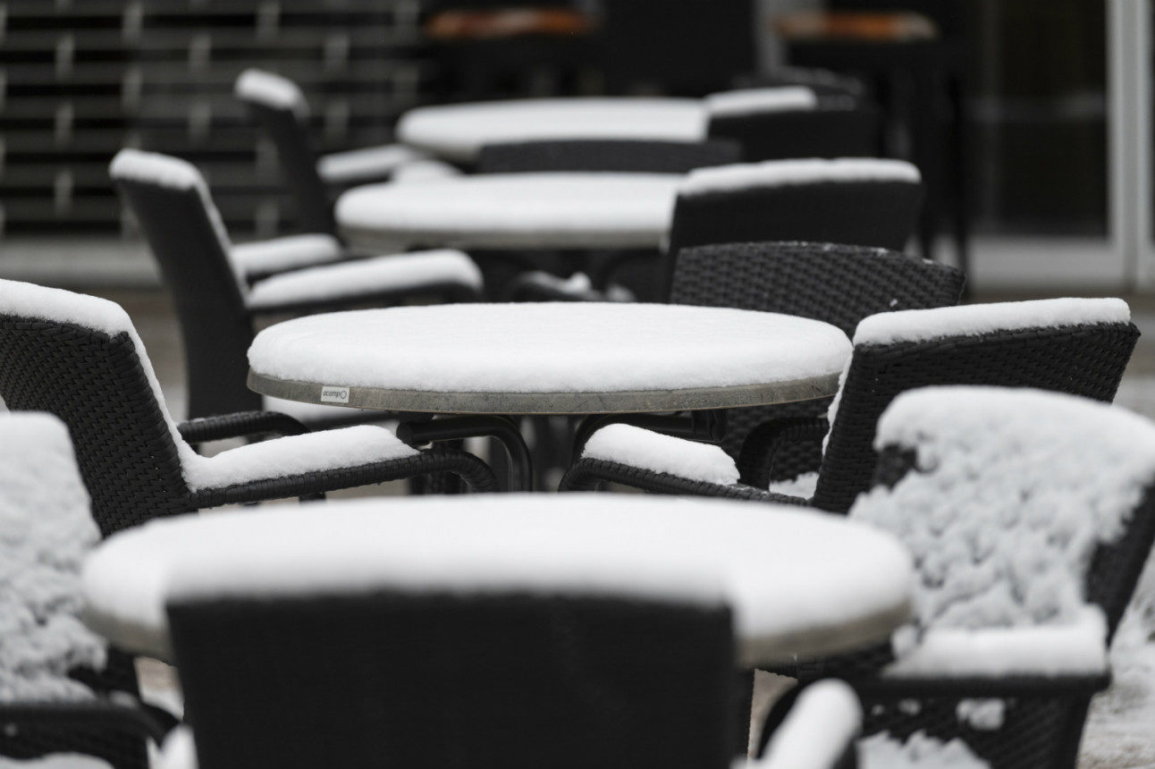 Snow-covered tables at a cafe in Titisee-Neustadt, Baden-Württemberg.