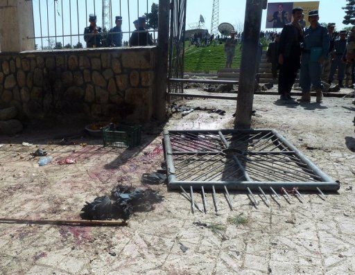 Afghan policemen on the scene of a suicide attack to Maymana, in the North of the country, on April 4th, 2012