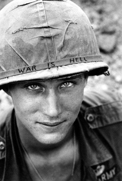 Vietnam War An unidentified U.S. Army soldier wears a hand lettered “War Is Hell” slogan on his helmet, in Vietnam on June 18, 1965. 