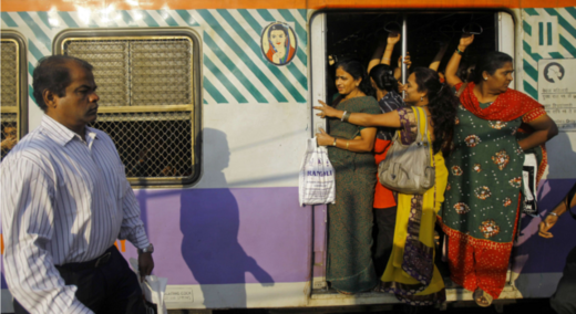 people, train at station in India