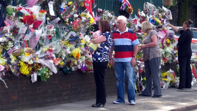 La veuve du soldat Lee Rigby devant les fleurs en mémoire du défunt 